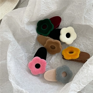 Colorful flocked flower hair clips in a soft plush texture for elegant side fringe styling