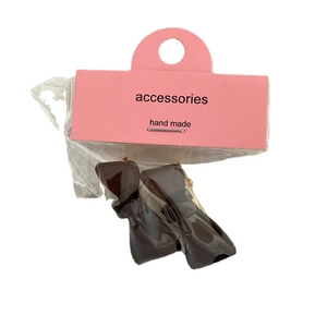Set of two brown acetate bow hair clips on pink card packaging for girls