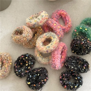 Close-up of colorful plush knitted donut hair ties showing soft texture and high elasticity
