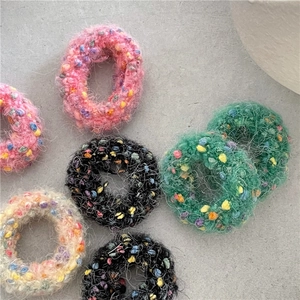 Cute plush donut hair ties in various colors with colorful speckled knit details