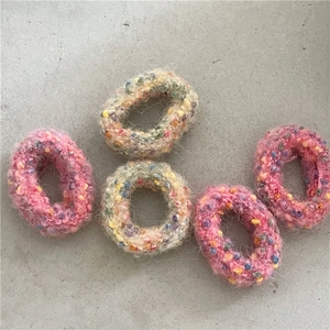 Detail of plush donut hair scrunchies with colorful polka dots in pink and beige