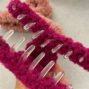 Close-up of fluffy purple teddy fleece hair claw clip showing soft plush texture