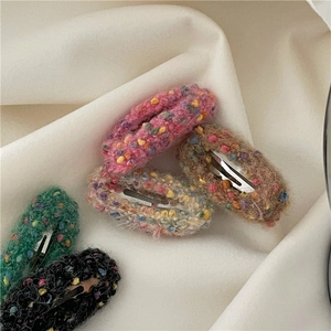 Close-up of soft plush donut hair clips with colorful knit textures and mohair fabric