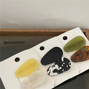 Detailed view of 6-piece acetate teardrop hair clips in tortoiseshell and marble patterns
