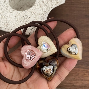 Elegant heart-shaped acetate hair ties set with sparkling rhinestones in four colors