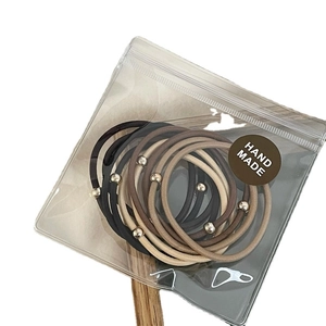 Set di 10 elastici per capelli minimalisti con perline dorate in toni terra