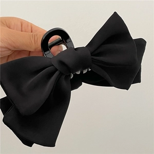 Elegant large black velvet bow hair claw clip for women's sophisticated hairstyles