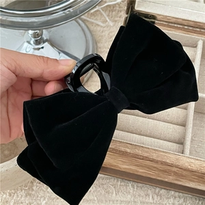 Detail shot of the premium black velvet texture and sturdy grip on this large bow hair claw