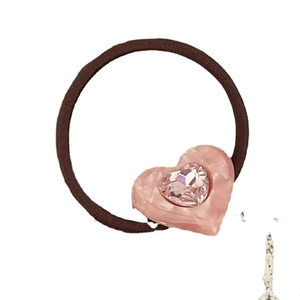 Elegant acetate pink heart hair tie with shimmering rhinestone detail on elastic band