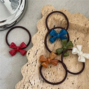 Five-piece set of acetate bow hair ties in red, blue, green, amber, and pearl white
