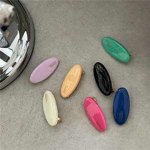 Detailed top view of colorful oval hair clips with gold France Handmade lettering
