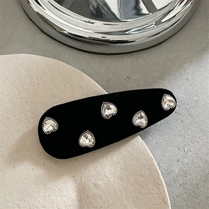 Elegant black velvet hair clip featuring five crystal hearts with silver beaded edges