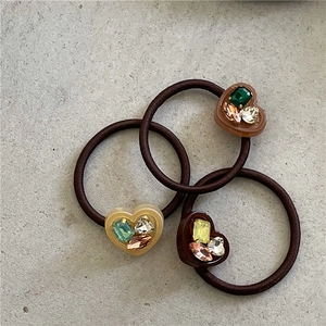 Three earth-toned heart rhinestone hair ties with colorful crystals and elastic bands
