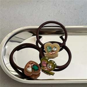 Three-piece set of heart-shaped rhinestone hair ties in brown, green, and beige colors