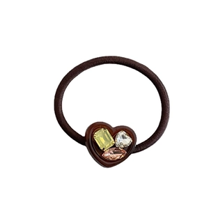 Brown elastic hair tie featuring heart resin ornament with sparkling multi-colored rhinestones