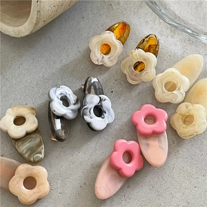 Cute floral hair clips in assorted colors like pastel pink and marble green for girls