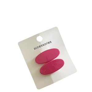 Pair of glossy oval rose pink acrylic hair clips on display card for spring styling