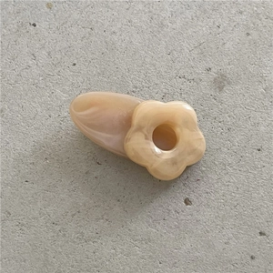 Detail of flower hair clip in milk tea brown with marble textured resin finish