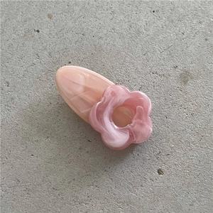 Detailed macro view of a pink marble-textured resin flower hair clip for girls