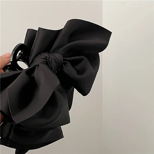 Elegant black satin fabric bow hair claw clip for women's sophisticated hairstyles