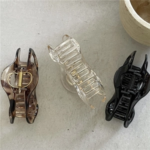 Detail view of brown leopard and clear cloud hair claw clips with strong metal springs