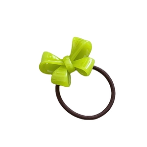 Vibrant green acetate bow hair tie with a high-stretch black elastic band on white background