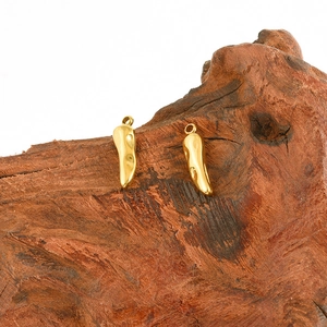 Macro shot of 304 stainless steel chili pepper charms with gold finish for DIY jewelry making