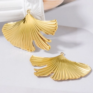 Set of two polished gold ginkgo leaf pendants with intricate vein textures for DIY jewelry