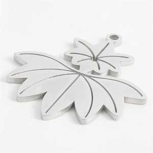 Macro shot of a 304 stainless steel maple leaf pendant with fine brushed metal texture