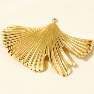Detailed close-up of golden ginkgo leaf pendant showing radial vein texture and hanging hole