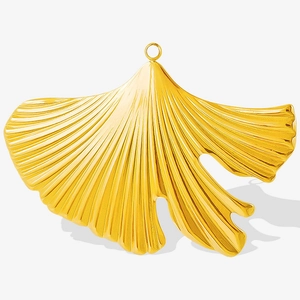 Macro shot of gold stainless steel ginkgo leaf pendant with detailed vein texture