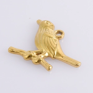 Detailed view of polished 18k gold bird pendant with intricate feather textures