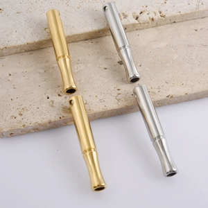 Macro shot of 304 stainless steel whistle pendants in polished gold and silver finishes