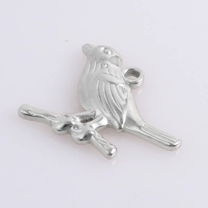 Close-up of bird on branch charm in polished stainless steel with embossed textures