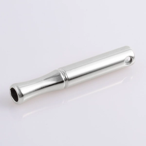Macro shot of polished silver stainless steel whistle pendant with smooth mirror finish