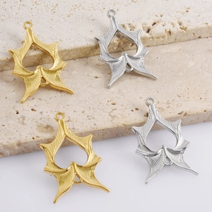 Detail of star-shaped hollow jewelry pendants in gold and silver finish with radial texture