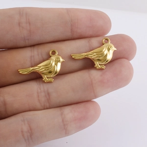Detailed macro of 18k gold plated bird charms showing feather texture for jewelry making
