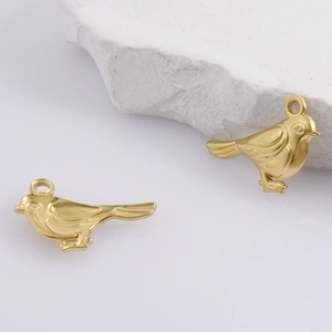 Detailed macro view of two 18k gold-plated 304 stainless steel bird charms with matte finish