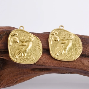 18k gold plated stainless steel owl pendant with embossed texture on wood