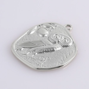Detailed relief of an owl pendant in silver stainless steel with oval irregular design