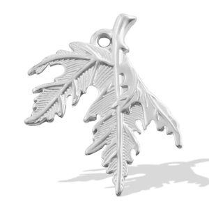 Macro shot of silver leaf pendant showing detailed leaf veins and stainless steel texture