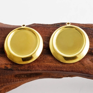 Close-up of golden stainless steel round bezel trays on rustic wood surface