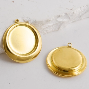 Golden 304 stainless steel round pendant trays for DIY jewelry making on white stones