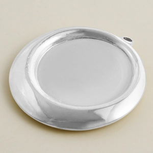 Macro detail of silver stainless steel round pendant tray with integrated hanging loop
