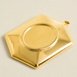 Detailed macro view of gold plated stainless steel rectangular pendant base with round tray