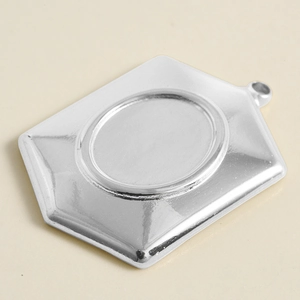 Detailed close-up of a silver hexagonal stainless steel pendant tray for DIY jewelry projects