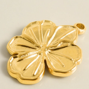 Macro view of gold 304 stainless steel flower pendant with detailed petal textures