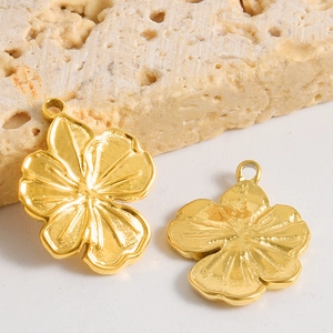 Matte gold 304 stainless steel flower pendants with petal texture on travertine stone