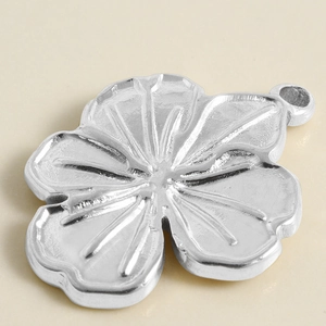 Macro view of 304 stainless steel flower pendant with detailed textured petals