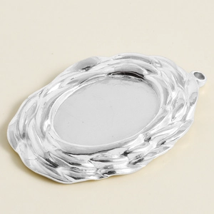 Macro view of 304 stainless steel oval pendant base with embossed braided texture edges